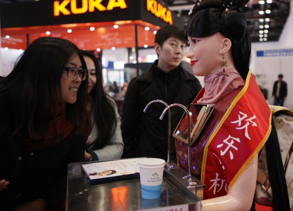 BEIJING, CHINA - NOVEMBER 23:  (CHINA OUT) Visitors look at a robot at the World Robot Exhibition 2015 at China National Convention Center on November 23, 2015 in Beijing, China. The World Robot Exhibition containing World Forum on Robot, World Robot Exhibition and World Adolescent Robot Contest will be held on Nov 23 to 25 at China National Convention Center in Beijing.  (Photo by ChinaFotoPress/ChinaFotoPress via Getty Images)